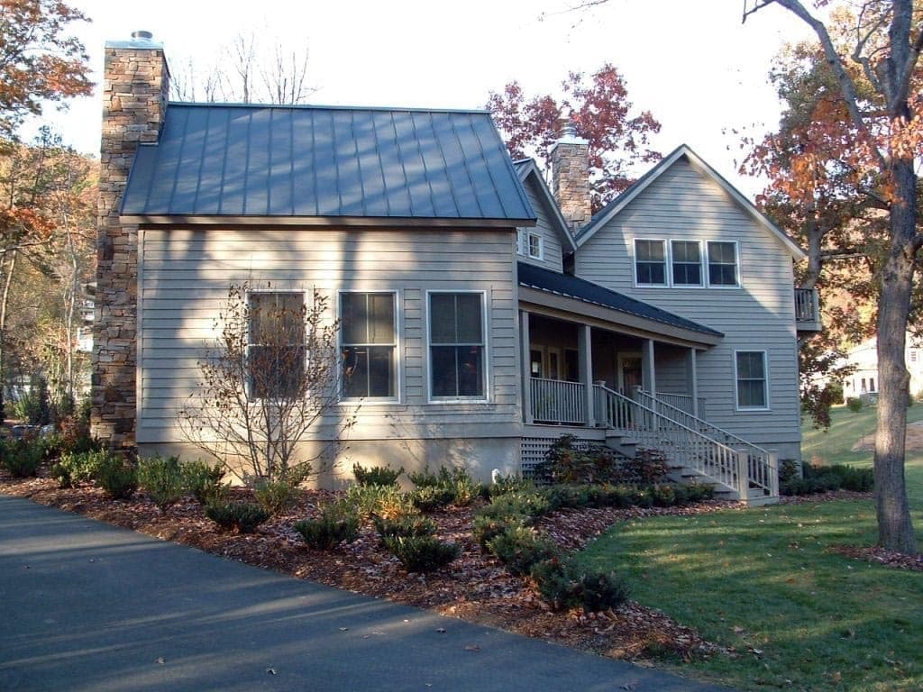 Custom mountain home with stone chimney and covered porch built by Blue Ridge Homes in Weaverville NC