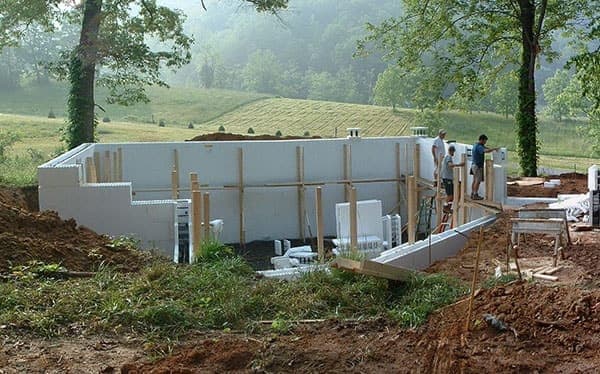 ICF foundation construction with crew on site